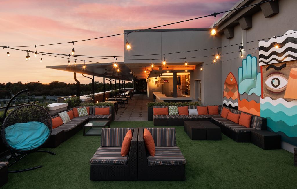 A patio with chairs and lights