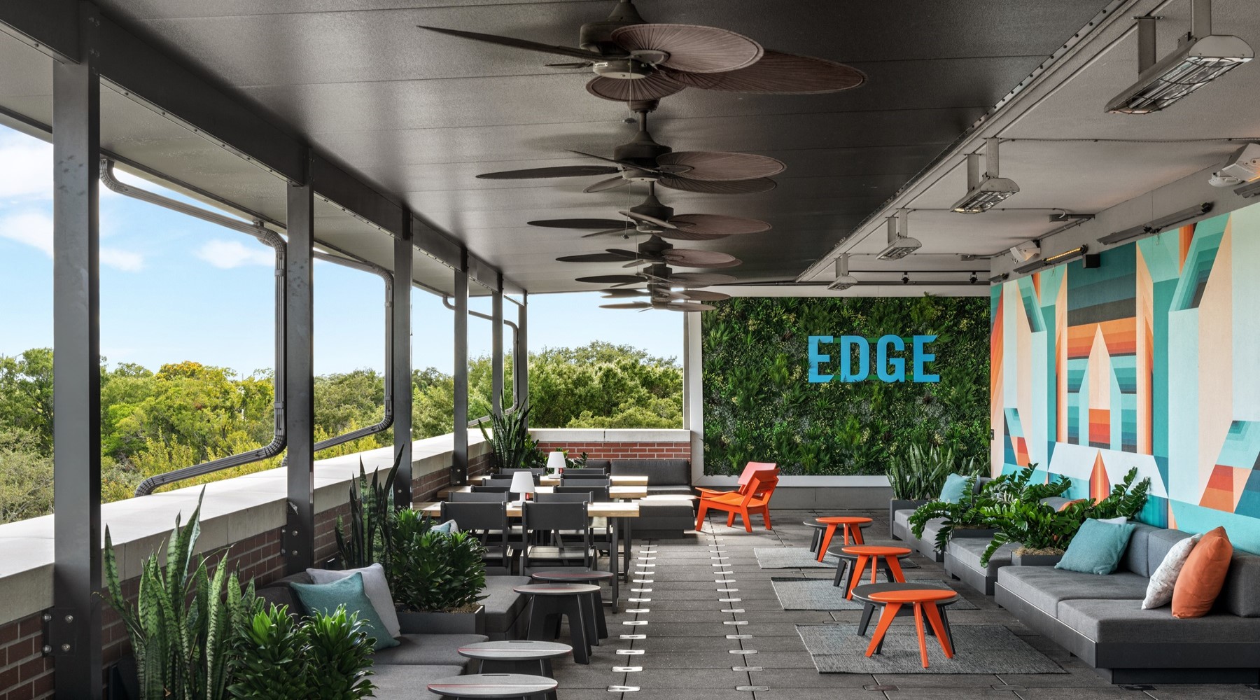 A patio with chairs and a fan at EDGE rooftop bar in South Tampa FL