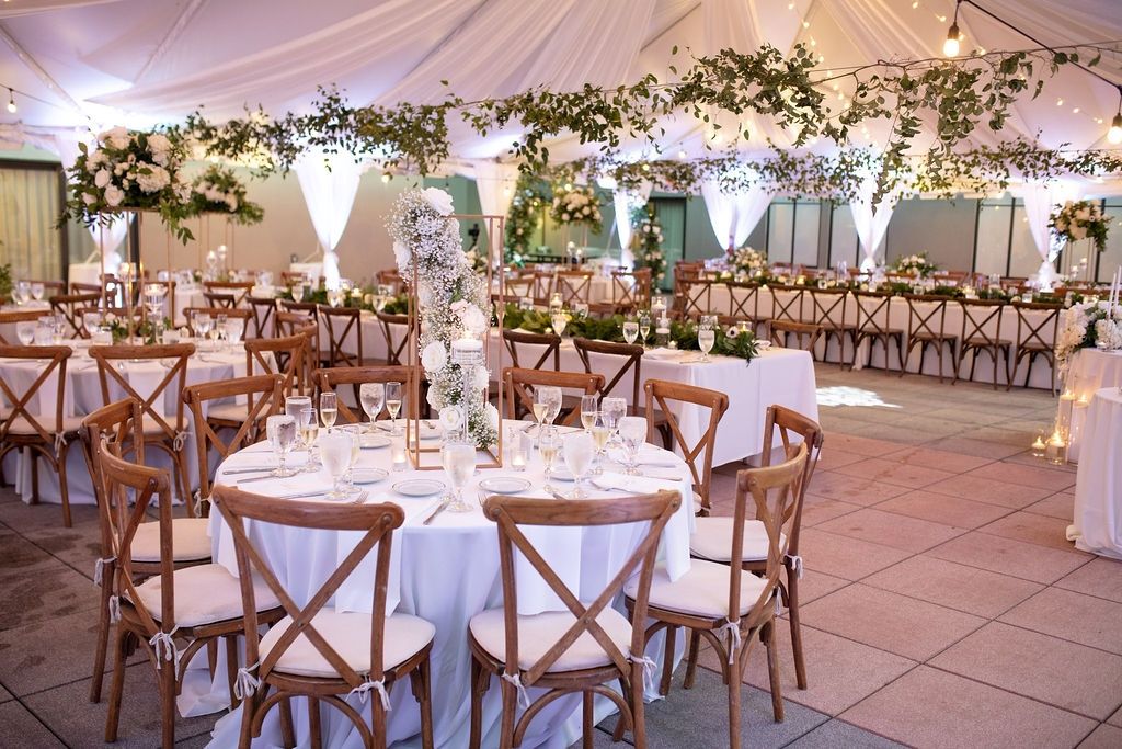 A set up of tables and chairs in a tent