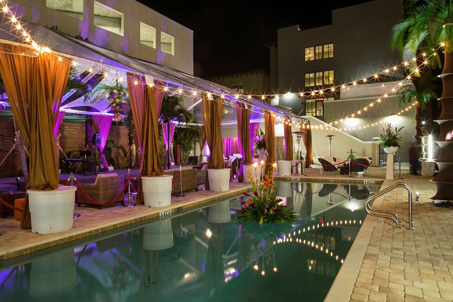 A pool with lights and a building