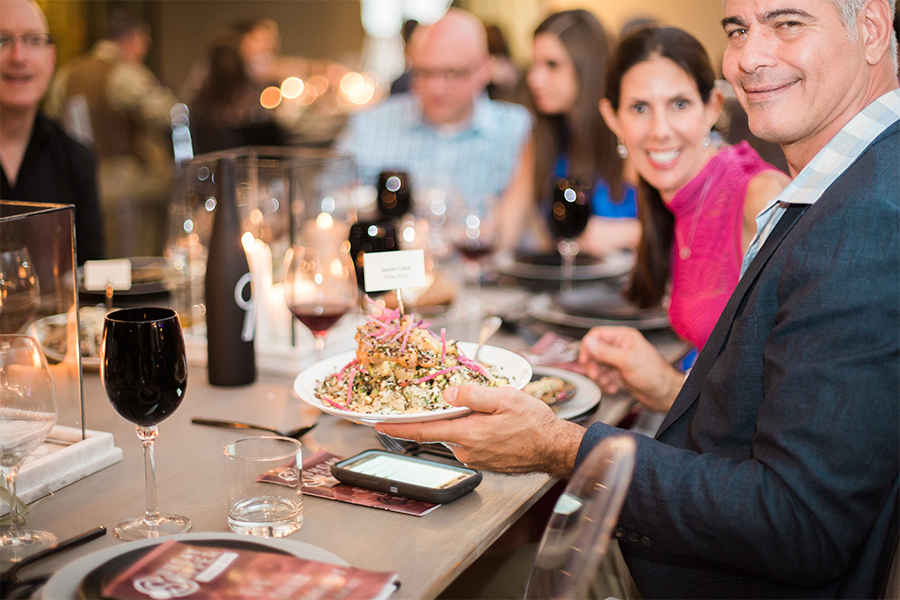 A group of people sitting at a table with food