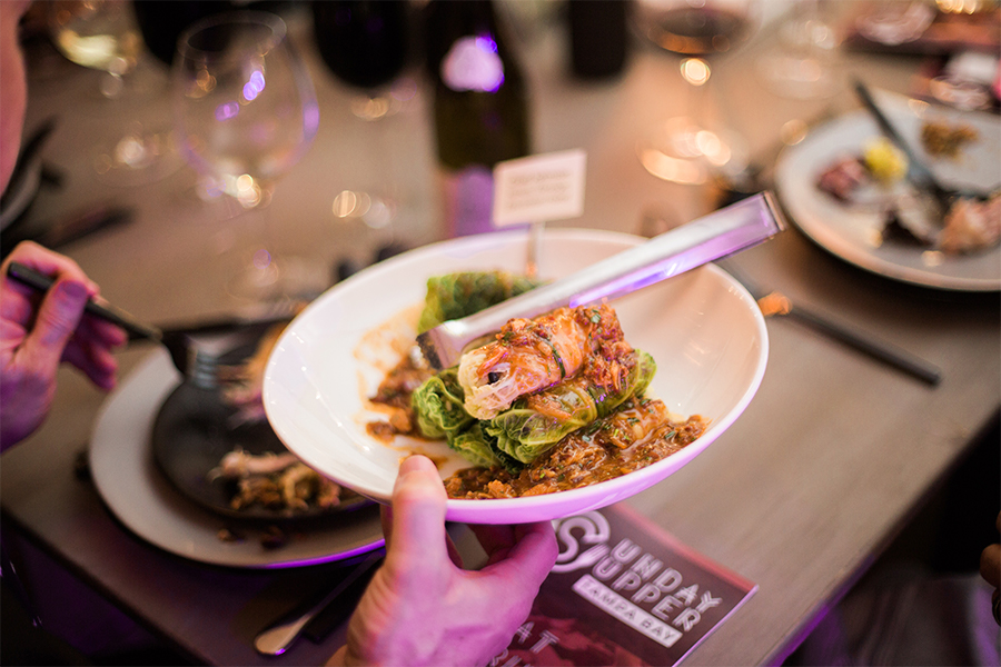 A person holding a plate of food