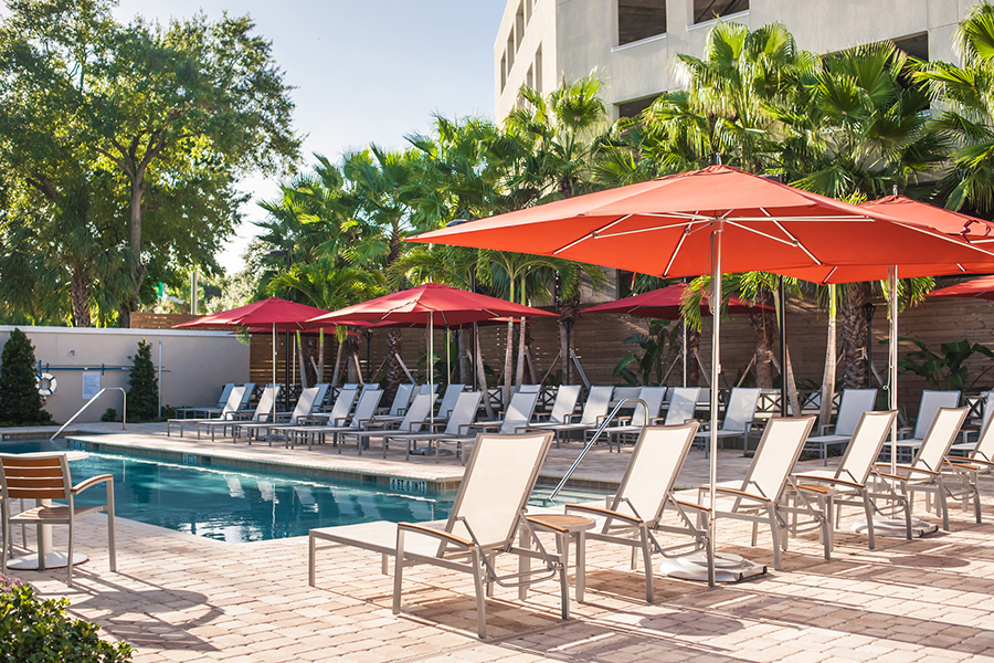 A pool with chairs and umbrellas