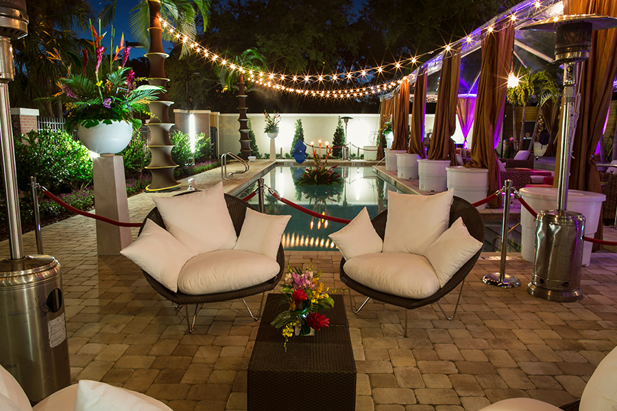 A patio with chairs and a pool