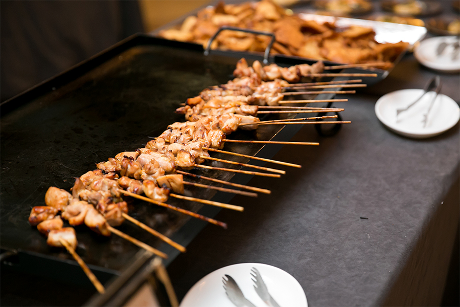 Skewers on a grill with meat on it