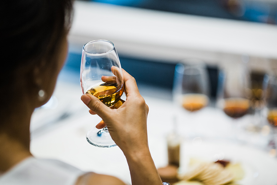 A person holding a glass of wine