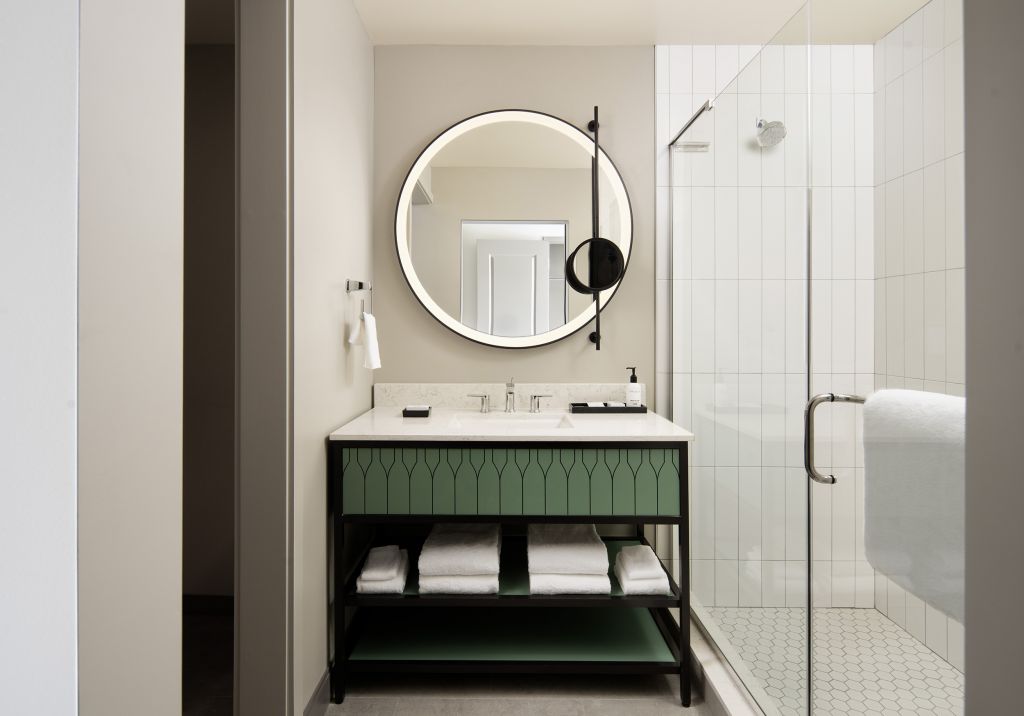 hotel guestroom bathroom with sink and shower