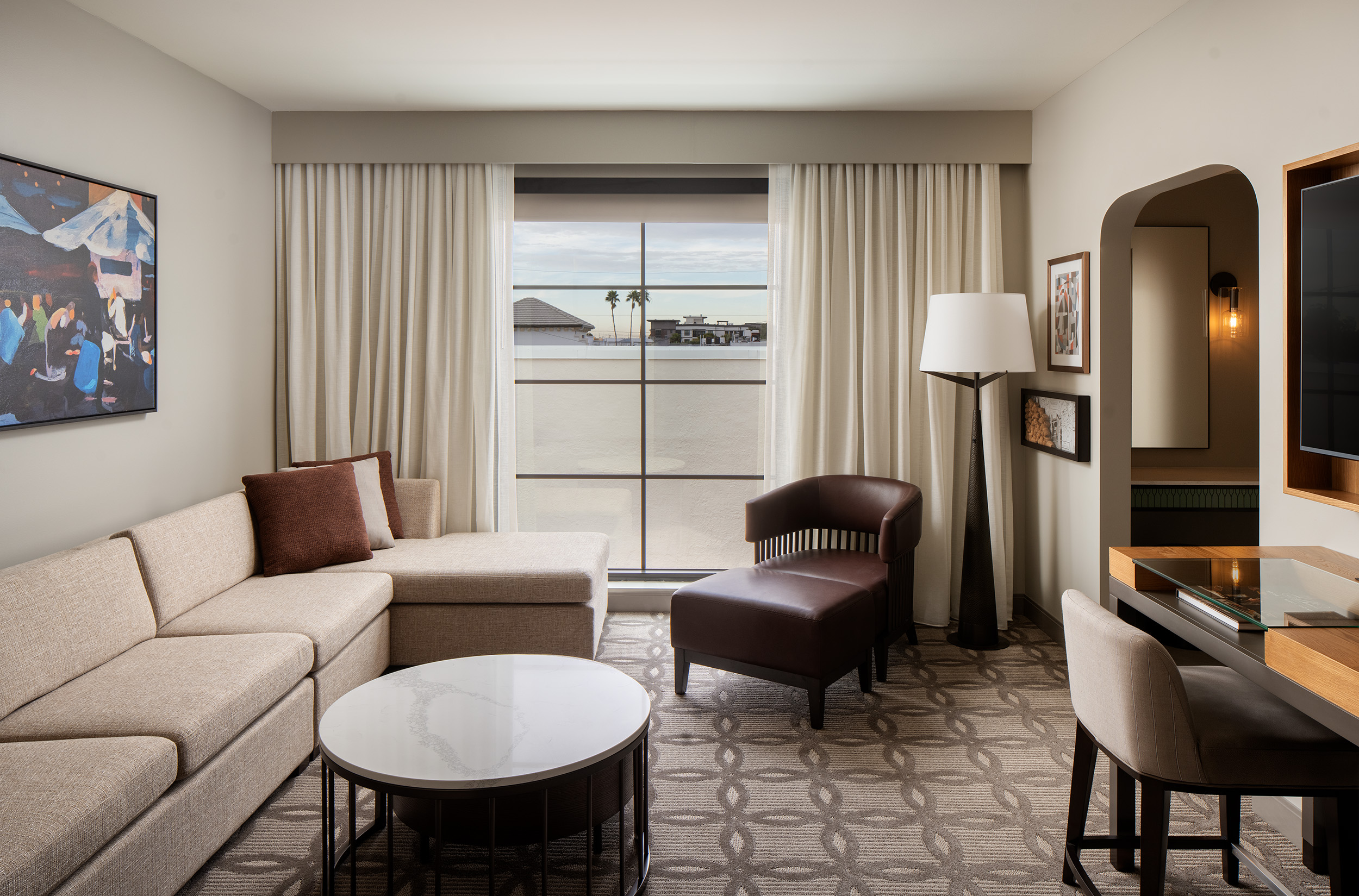 room in hotel guestroom with couch and tv