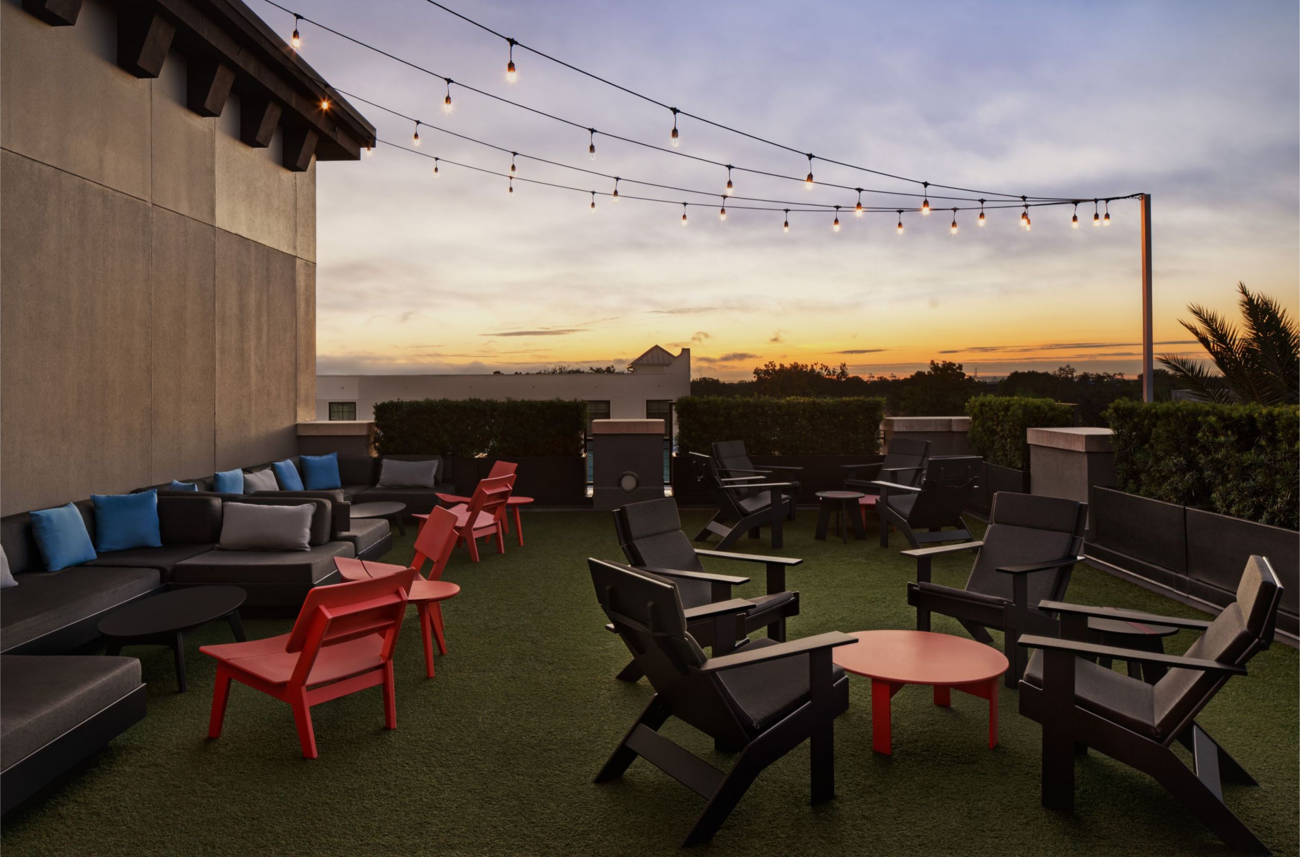 a rooftop cocktail lounge seating with patio lights EDGE at dawn in Epicurean Hotel in South Tampa