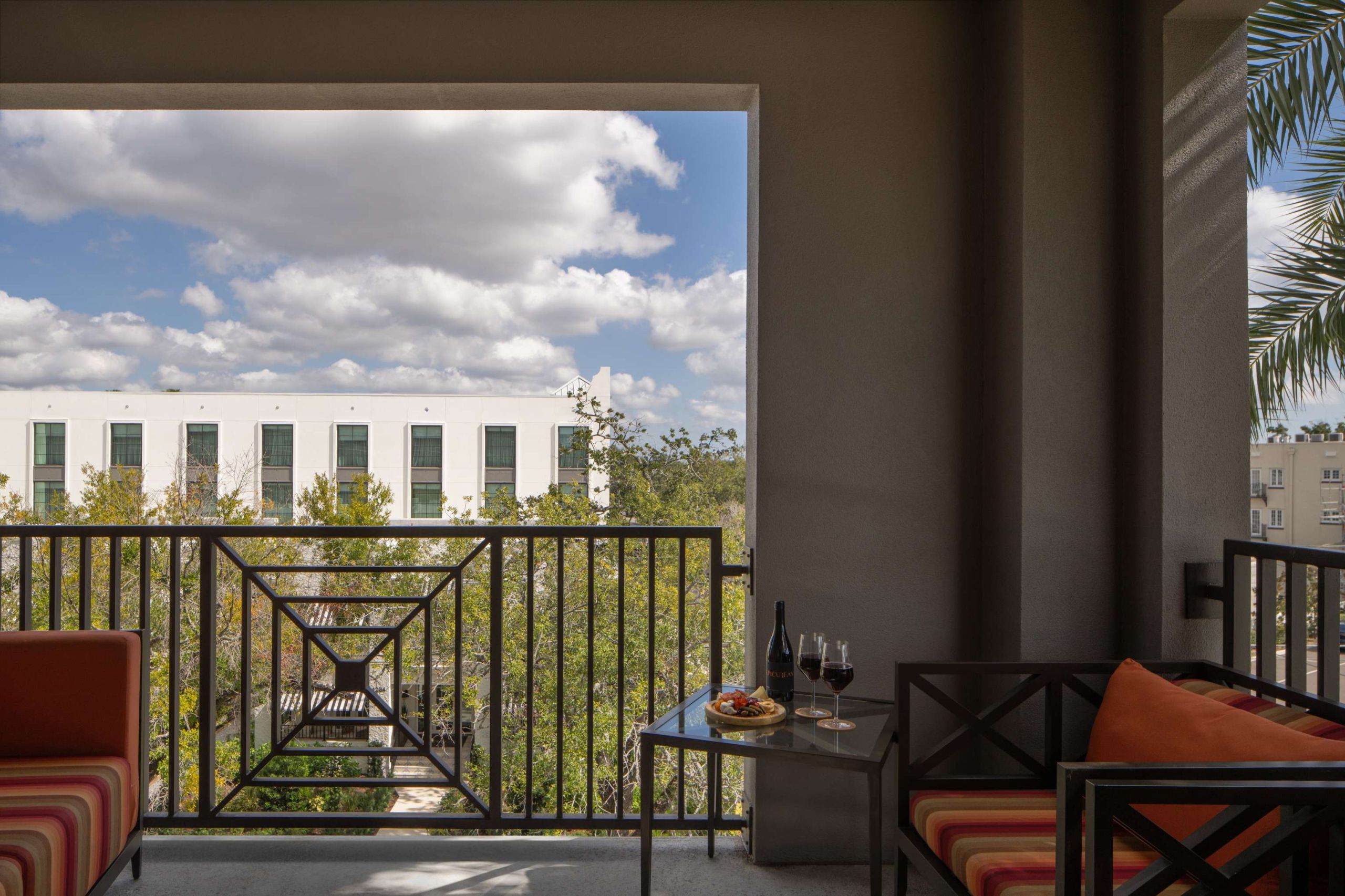 a hotel suite balcony with seating at Epicurean Hotel in South Tampa