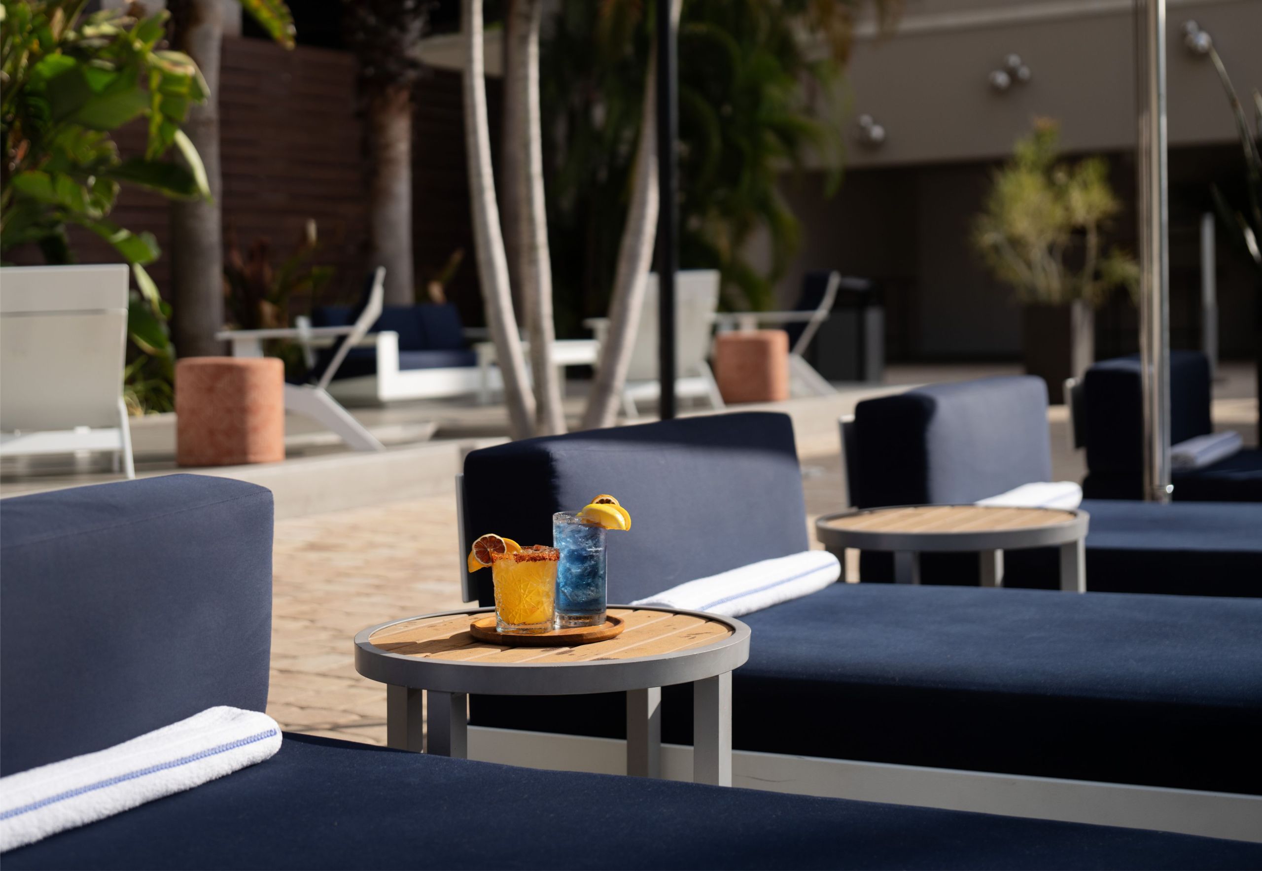 a pool vignette setting of lounge chairs and small tables at Epicurean Hotel in South Tampa