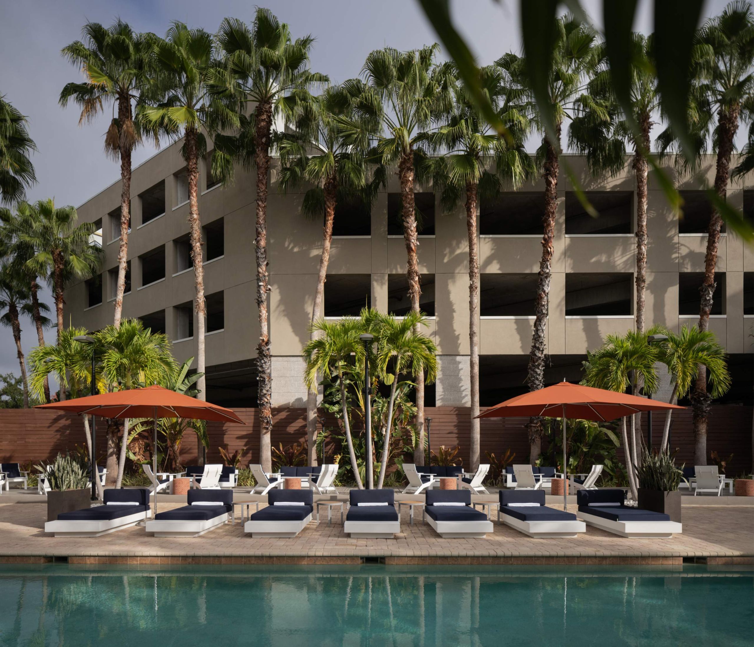 a hotel pool with lounge chairs and umbrellas at Epicurean Hotel in South Tampa